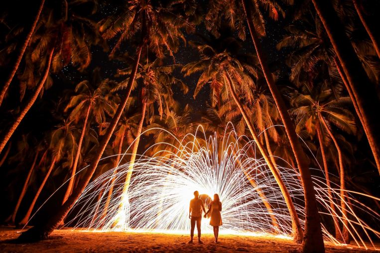 couple-fire-palm-trees-night.jpg
