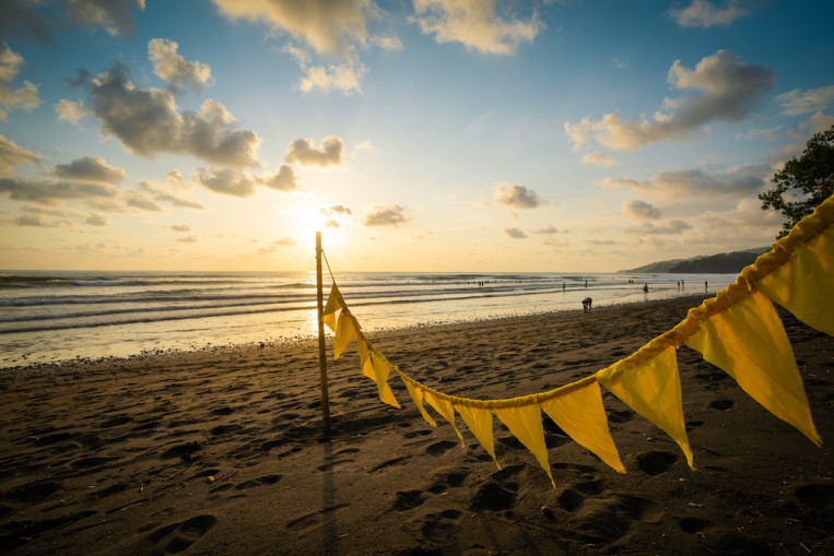 yellow-flags-beach-sunset-clouds.jpg