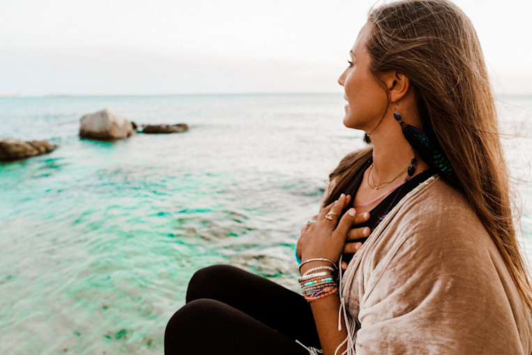 rachel-brathen-hands-heart-ocean-rocks.jpg