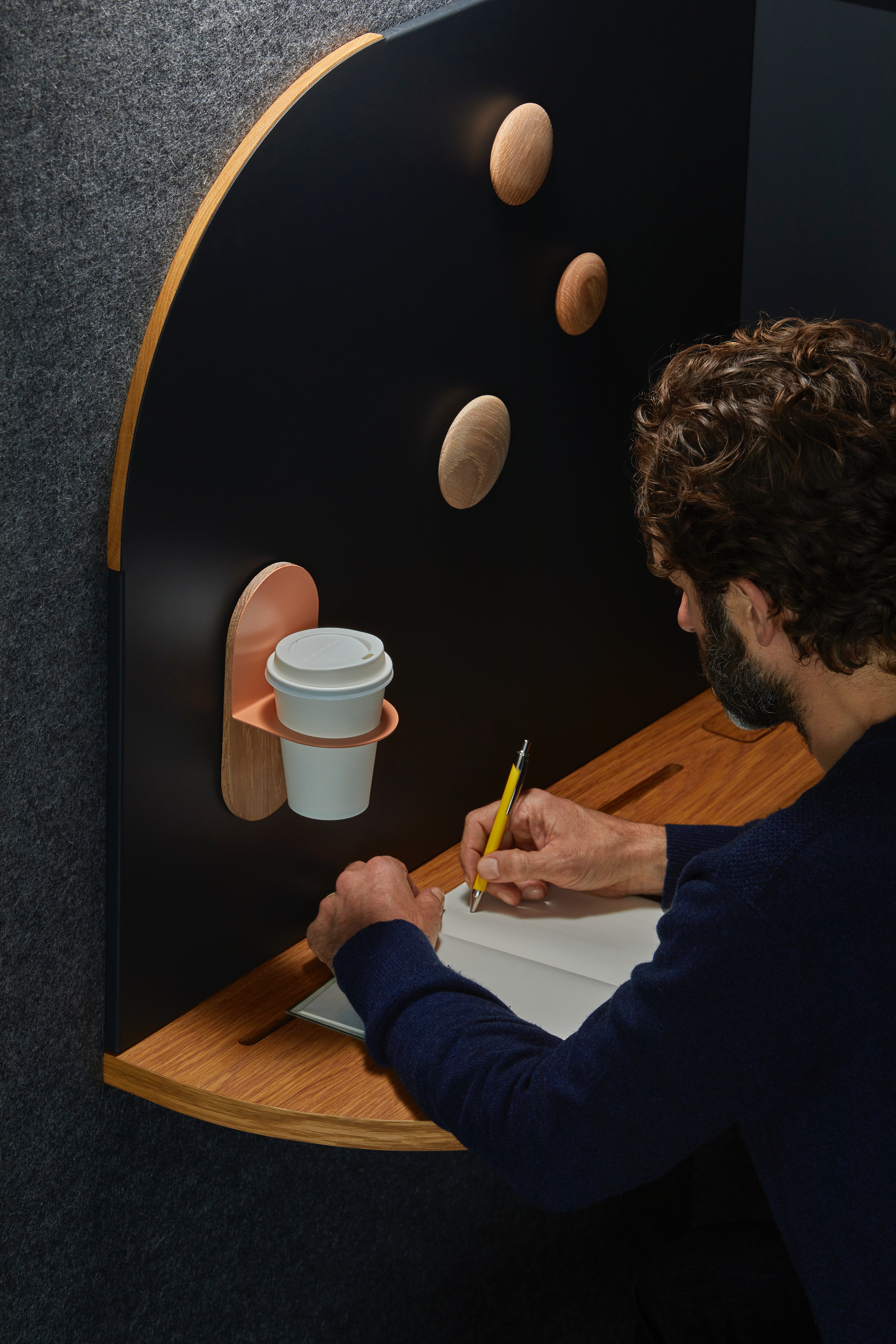 Man writing in a cafeteria