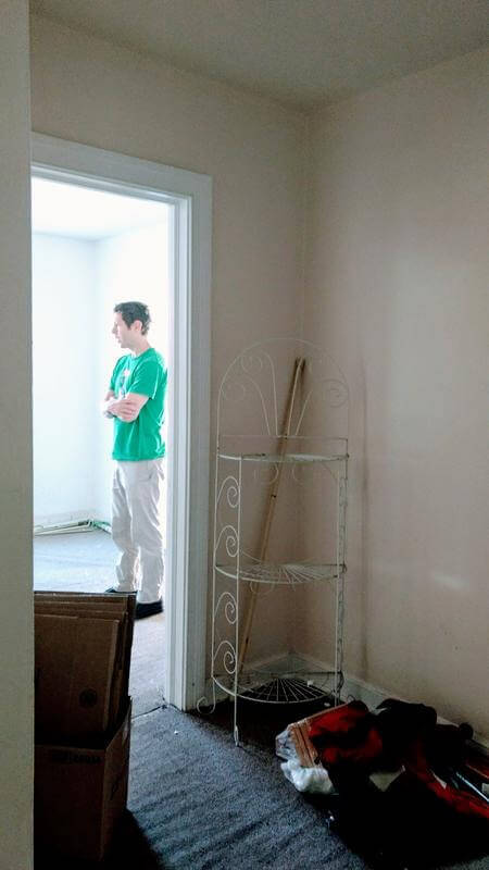 View of the hallway with a dark carpet