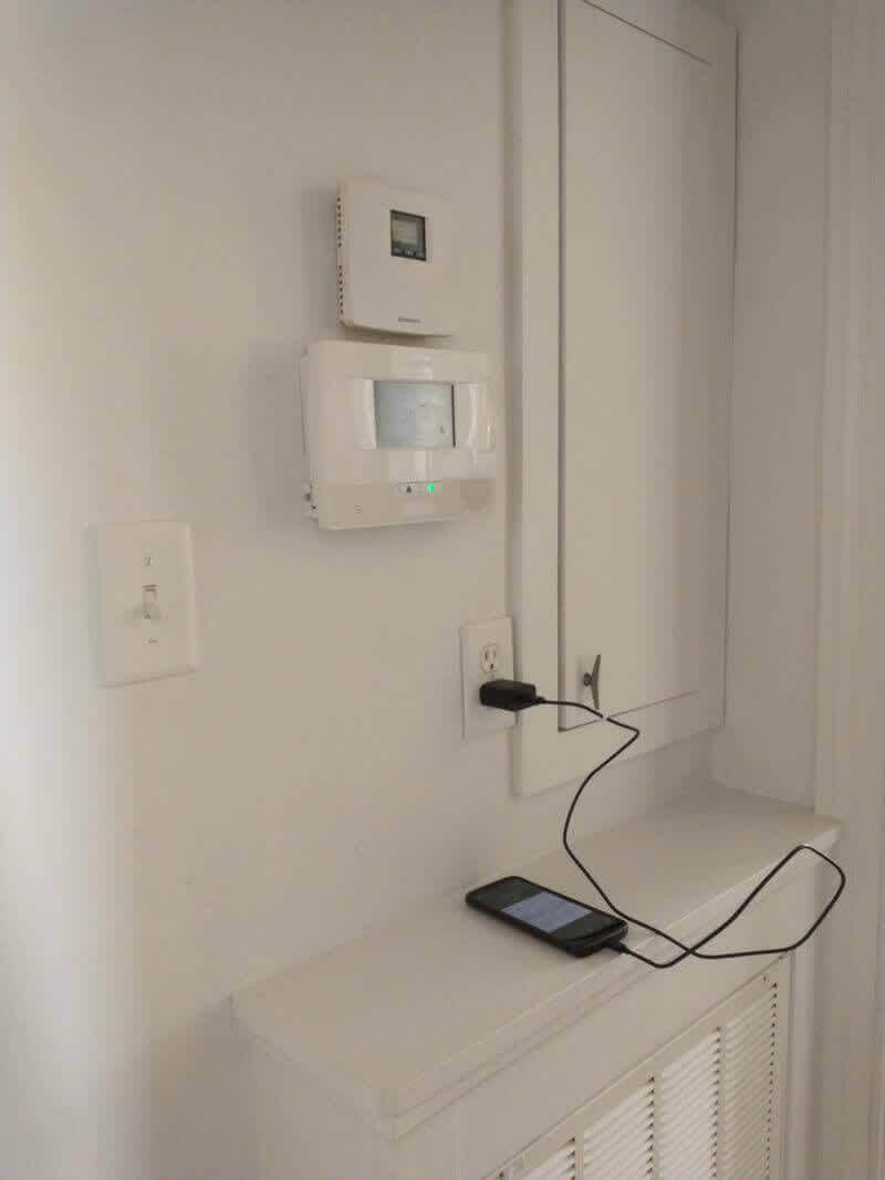 Hallway with thermostat and charging nook