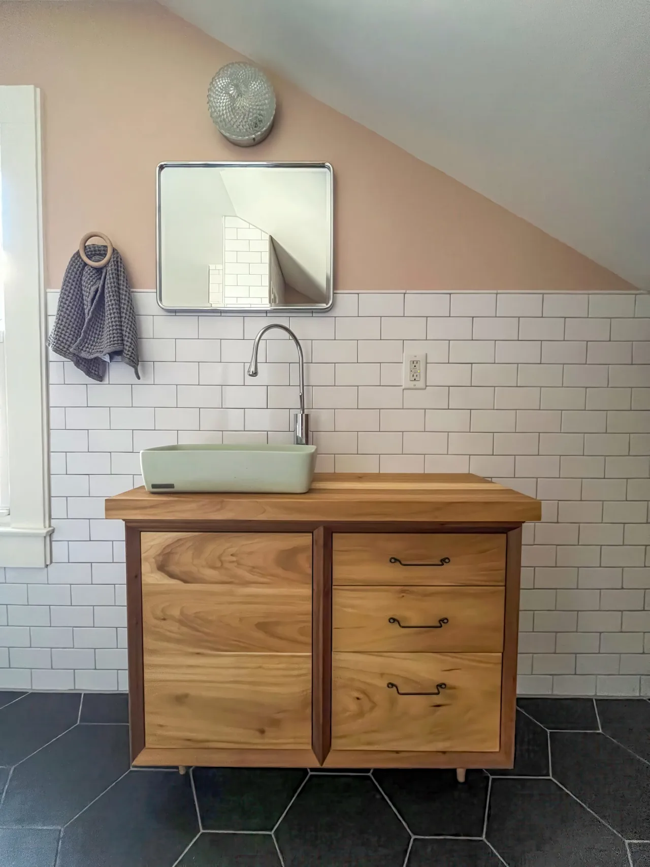 Bathroom with a custom live-edge wood vanity, a green vessel sink, white subway tile, and a hexagon slate floor.