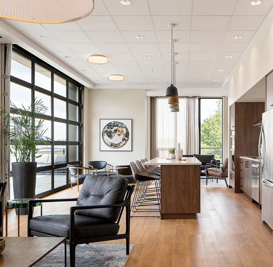 Friends gather in the social room with complete kitchen, bar seating, and table. 