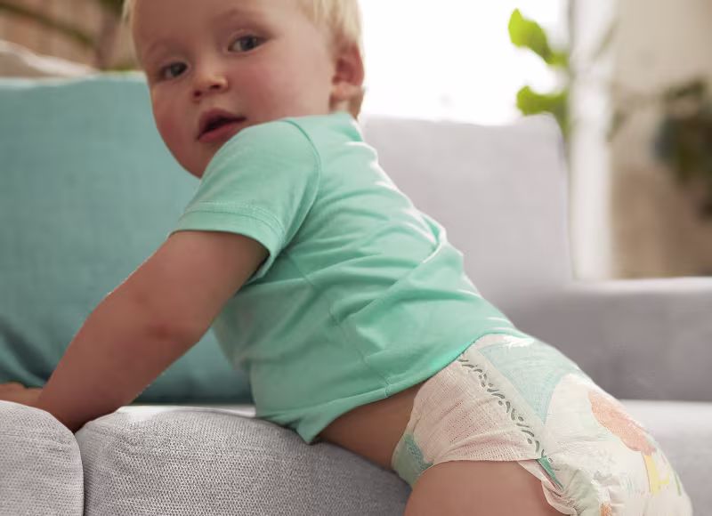 Standing baby wearing a Pampers Baby-Dry nappy Standing baby wearing a Pampers Baby-Dry nappy