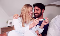 A couple looking at a pregnancy test