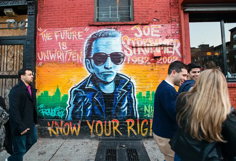 East Village mural of Joe Strummer with “The future is unwritten” painted above him.