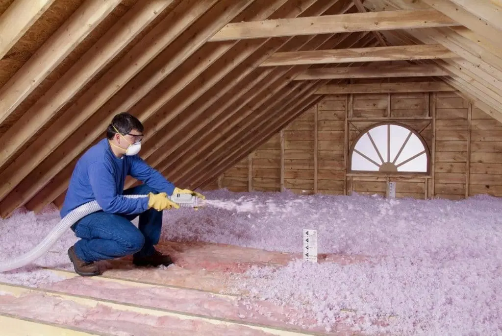 worker is working with spray foam