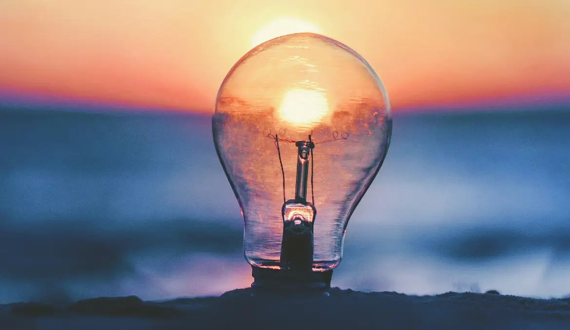 Lightbulb in front of a sunset