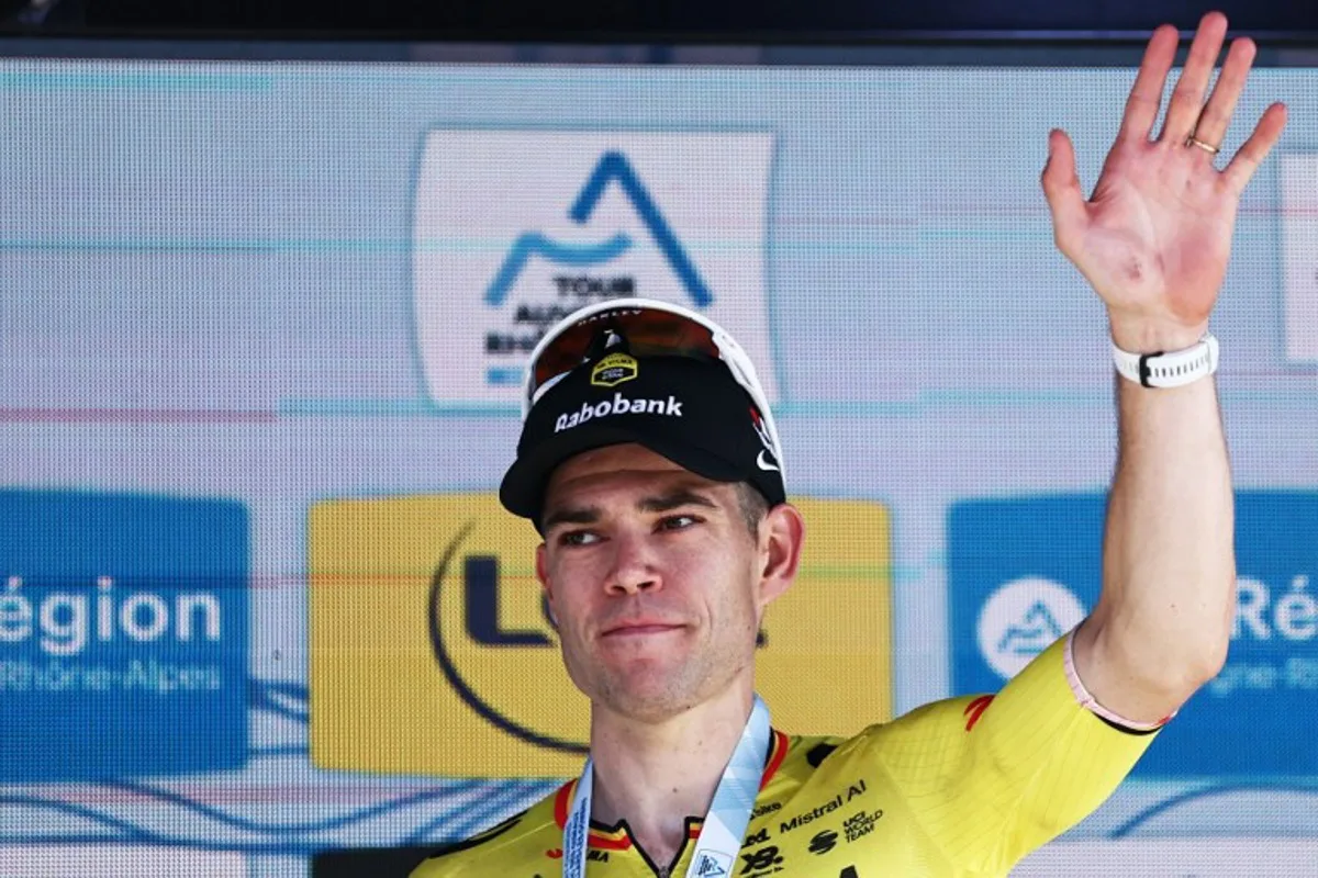 Stage winner Team Visma | Lease a Bike's Belgian rider Wout Van Aert celebrates on the podium of the 5th stage of the Tour Auvergne-Rhone-Alpes cycling race (formerly known as the Criterium du Dauphine), 195,8km between Saint-Chamond and Villars-les-Dombes, central France, on June 11, 2026. Anne-Christine POUJOULAT / AFP