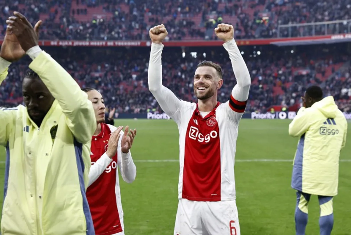 Ajax' Dutch midfielder Kian Fitz-Jim and Ajax's English midfielder #6 Jordan Henderson celebrate the victory of their team at the end of the Dutch Eredivisie football match between AFC Ajax and Feyenoord at the Johan Cruijff ArenA in Amsterdam, on February 2, 2025. Ajax won 2-12 over Feyenoord. MAURICE VAN STEEN / ANP / AFP