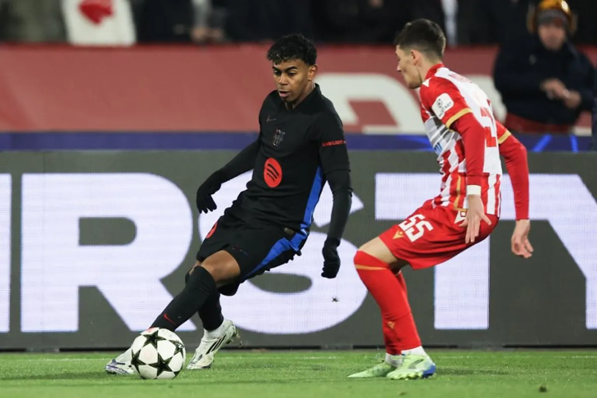 Barcelona's Spanish forward #19 Lamine Yamal (L) and Crvena Zvezda Beograd's Serbian forward #55 Andrija Maksimovic fight for the ball during the UEFA Champions League, League phase - Matchday 4 football match between Crvena Zvezda Beograd and FC Barcelona, at the Rajko-Mitic Stadium, in Belgrade, on November 6, 2024.  Pedja Milosavljevic / AFP