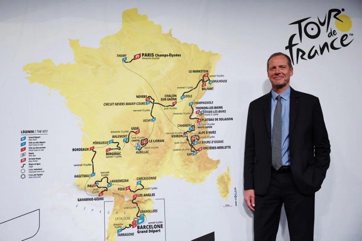 Tour de France General Director Christian Prudhomme poses for a picture in front of the map showing the women's route during the presentation of the official routes of the 2026 edition of the men's and women's Tour de France cycling race in Paris on October 23, 2025. Anne-Christine POUJOULAT / AFP