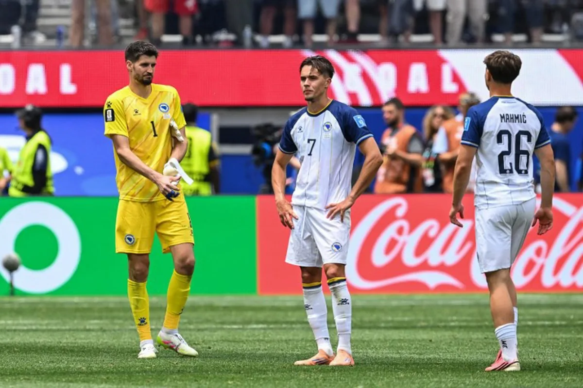 Bosnia-Herzegovina's goalkeeper #01 Nikola Vasilj, defender #07 Amar Dedic, and midfielder #26 Ermin Mahmic react after losing the 2026 World Cup Group B football match between Switzerland and Bosnia and Herzegovina at Los Angeles Stadium in Inglewood on June 18, 2026. Patrick T. Fallon / AFP