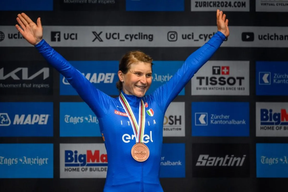 Third-placed Italy's Elisa Longo Borghini celebrates during the podium ceremony of the women's Elite Road Race cycling event as part of the UCI 2024 Road World Championships, in Zurich, on September 28, 2024.  Fabrice COFFRINI / AFP