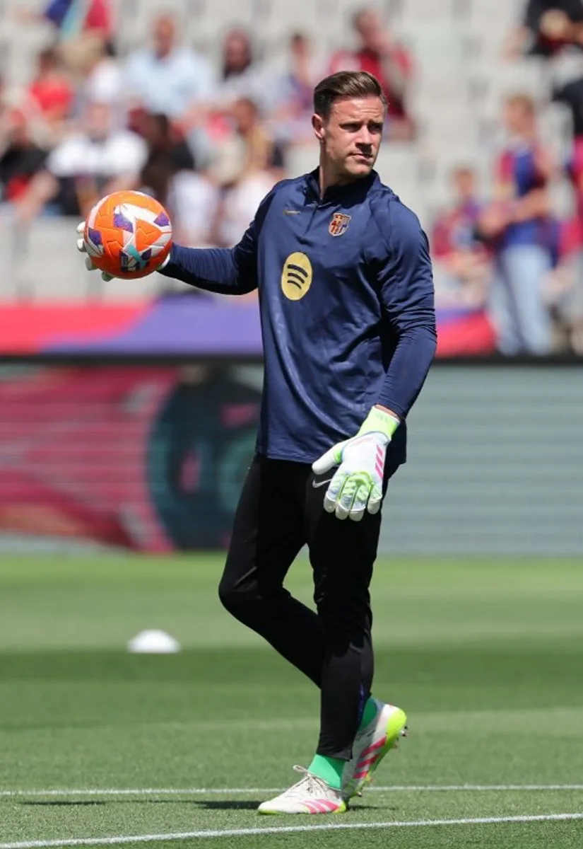 Barcelona's German goalkeeper #01 Marc-Andre Ter Stegen warms up before the Spanish league football match between FC Barcelona and Real Madrid CF at Estadi Olimpic Lluis Companys in Barcelona, on May 11, 2025. LLUIS GENE / AFP