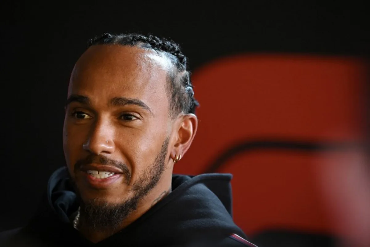 Mercedes' British driver Lewis Hamilton speaks with journalists in the paddock ahead of the Formula One Grand Prix race at The Circuit Zandvoort, western Netherlands, on August 22, 2024. The Formula One Zandvoort Grand Prix race will take place on August 25, 2024. JOHN THYS / AFP