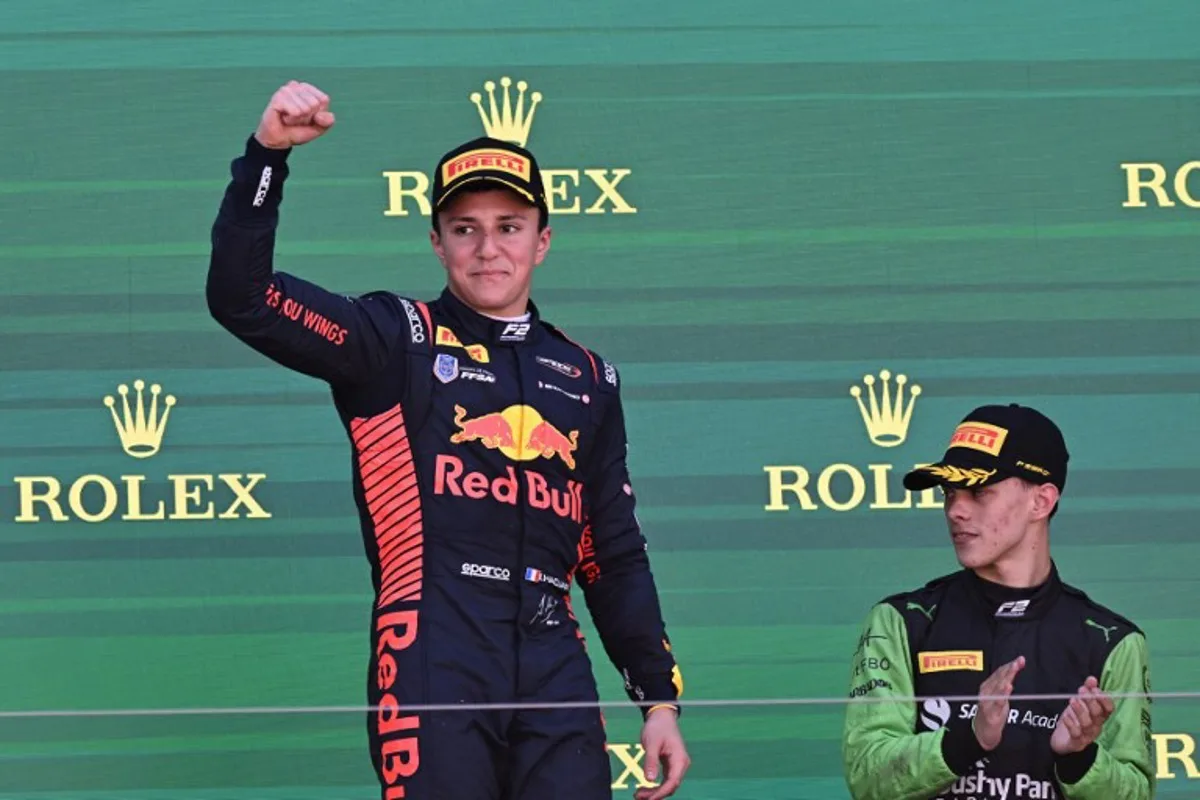 Campos Racing's French driver Isack Hadjar (L) celebrates victory on the podium along with third-placed Rodin Motorsport's Barbadian driver Zane Maloney after the Australian Formula 2 Grand Prix at the Albert Park Circuit in Melbourne on March 24, 2024.   WILLIAM WEST / AFP