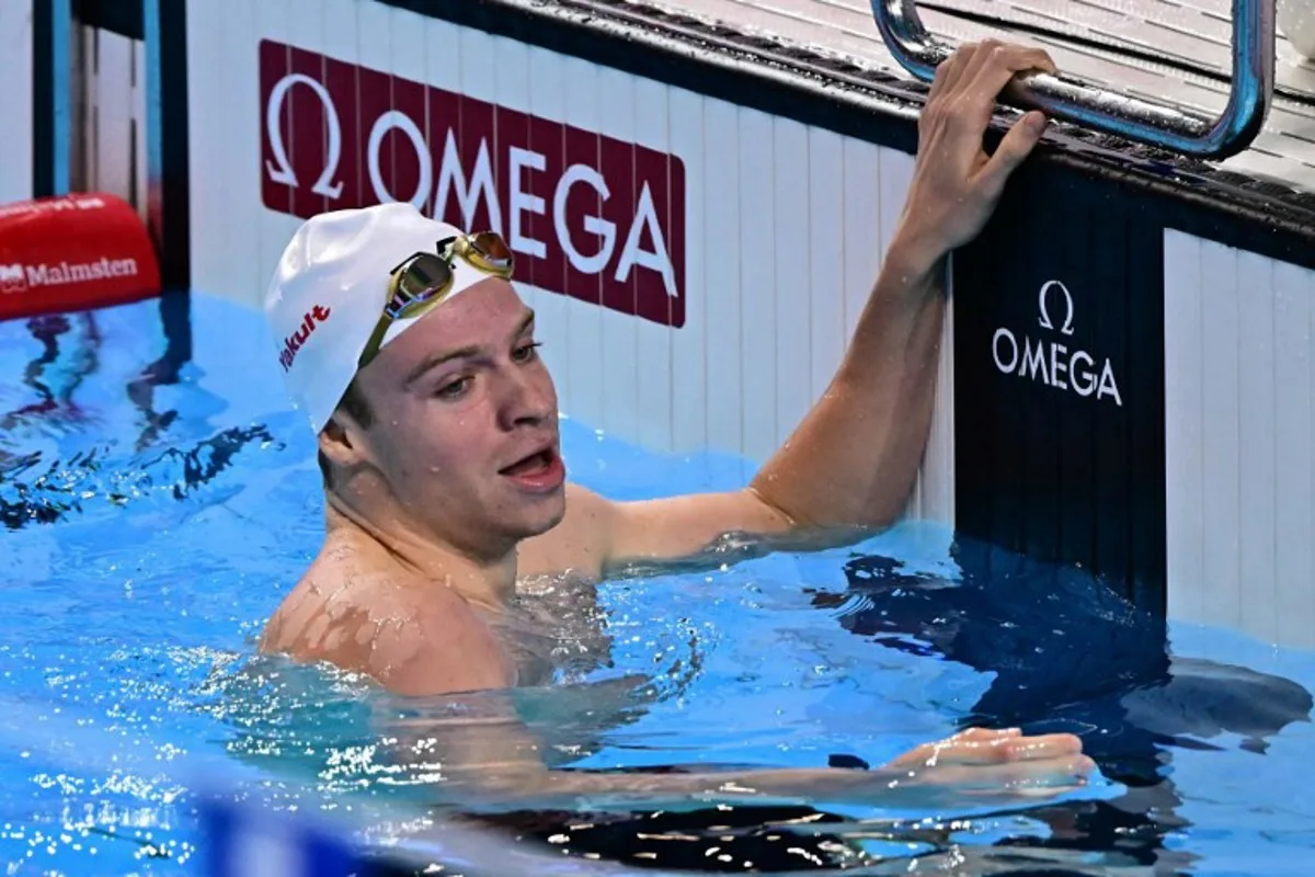 France's swimmer Leon Marchand celebrates winning the final of the men's 200m individual medley swimming event during the 2025 World Aquatics Championships in Singapore on July 31, 2025. MANAN VATSYAYANA / AFP