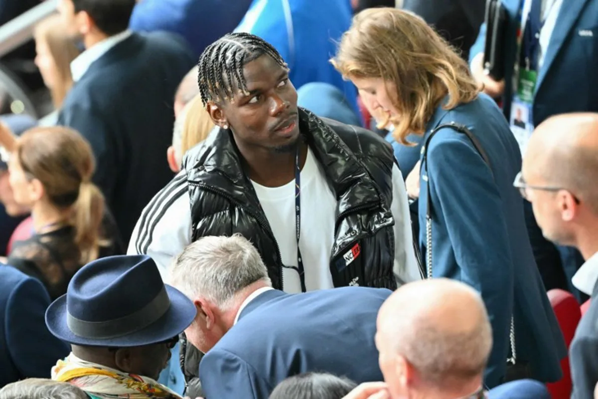 French football player Paul Pogba arrives in the tribunes before the start of the UEFA Euro 2024 round of 16 football match between France and Belgium at the Duesseldorf Arena in Duesseldorf on July 1, 2024.  Alberto PIZZOLI / AFP