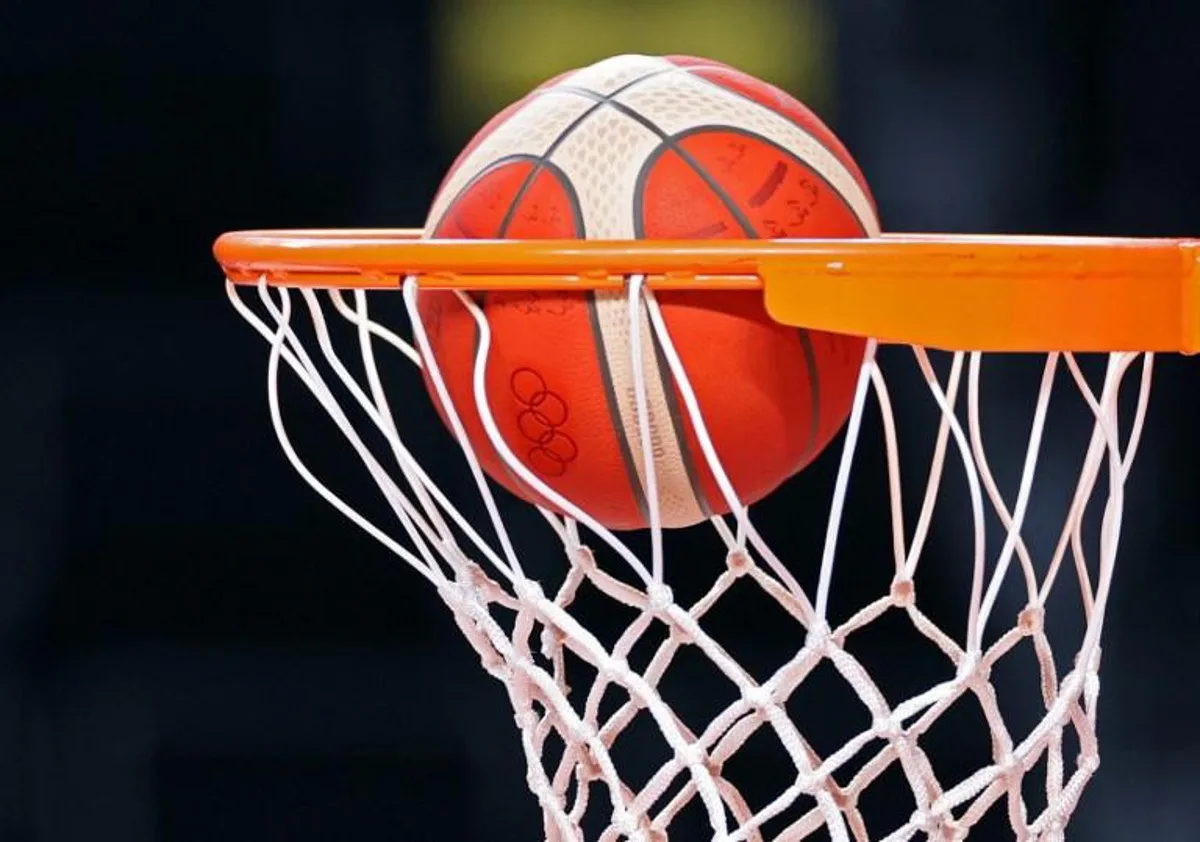 An Olympic basketball drops through a net during Spain's basketball team training session at the Saitama Super Arena in Saitama on July 23, 2021, ahead of the Tokyo 2020 Olympic Games.   Thomas COEX / AFP