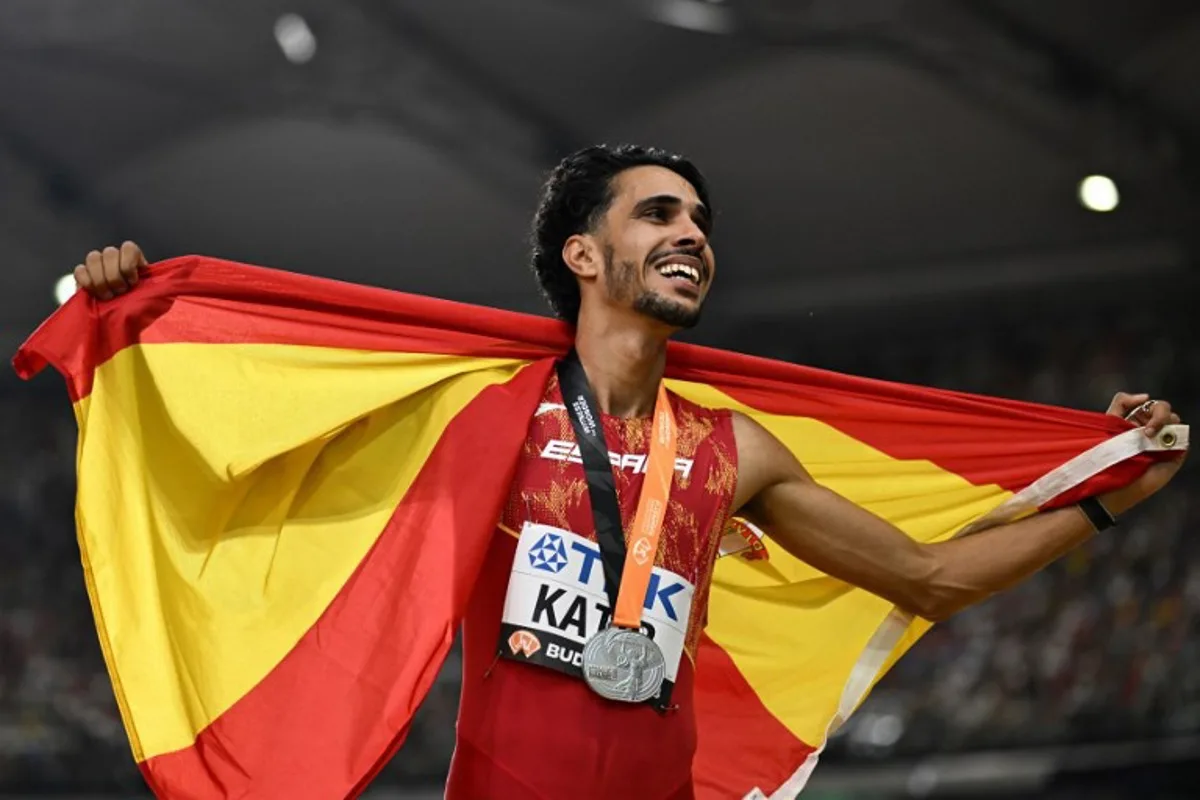 Spain's Mohamed Katir celebrates with his national flag after finishing second in the men's 5000m final during the World Athletics Championships at the National Athletics Centre in Budapest on August 27, 2023.  Jewel SAMAD / AFP