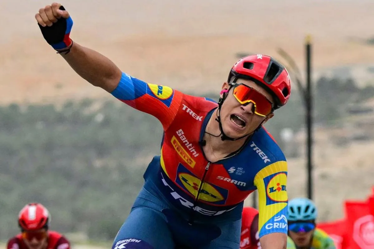 Lidl-Trek team's Italian rider Jonathan Milan reacts as he wins the first stage of the UAE Tour cycling race from Shams Solar Power Station Madinat Zayed to Liwa Palace in Abu Dhabi on February 17, 2025.  Giuseppe CACACE / AFP