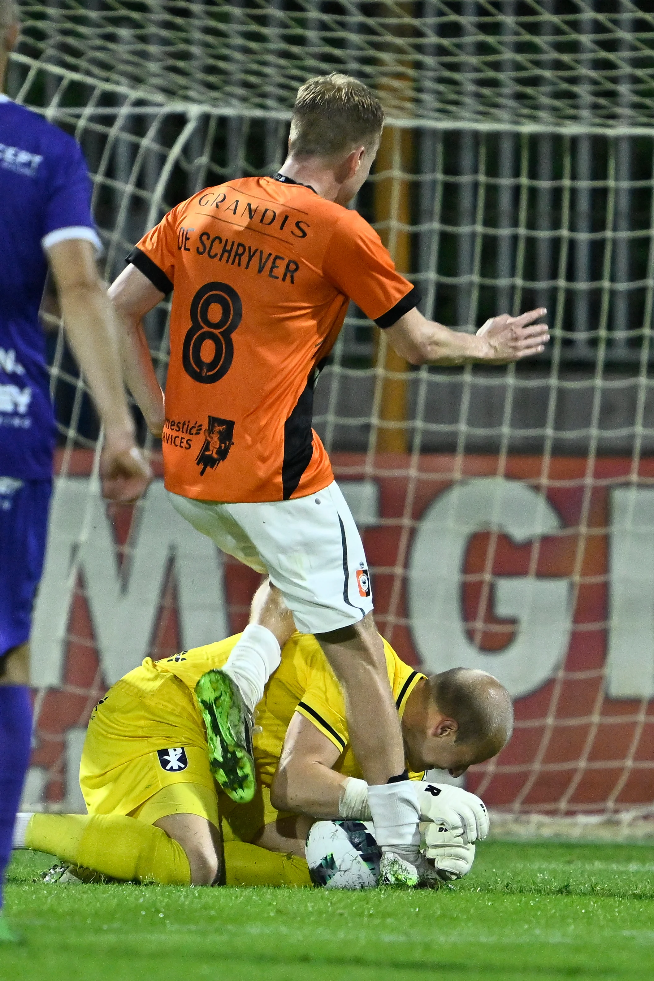 Deinze's Guillaume de Schryver and Patro Eisden's goalkeeper Jordi Belin fight for the ball during a soccer match between Patro Eisden and KMSK Deinze, Saturday 12 August 2023 in Maasmechelen, on day 1/30 of the 2023-2024 'Challenger Pro League' second division of the Belgian championship. BELGA PHOTO JOHAN EYCKENS