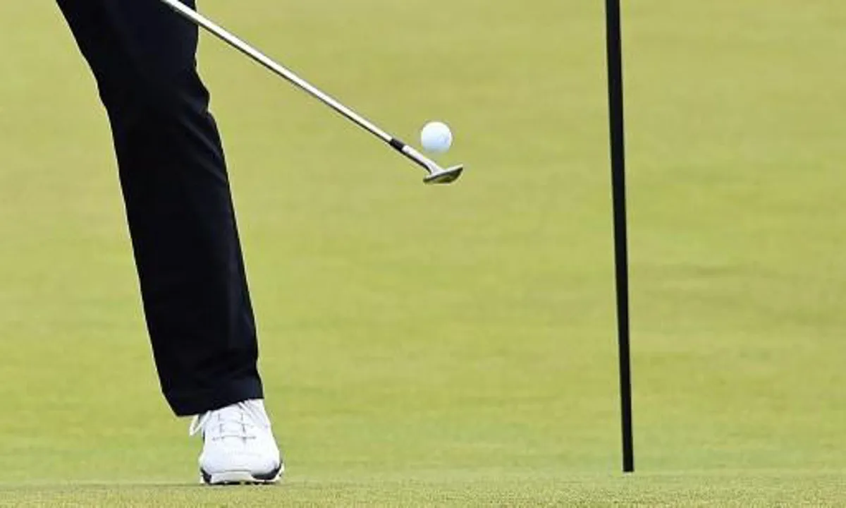 US golfer Jordan Spieth balances the ball on his club as he plays on the 2nd green during a practice round on The Old Course at St Andrews in Scotland, on July 13, 2015, ahead of The 2015 Open Golf Championship which runs July 16-19. US golfer Jordan Spieth arrives at St Andrews with a shot at becoming just the second man - after Ben Hogan in 1953 - to win the first three majors of the year, setting up the mouthwatering prospect of him pulling off the Grand Slam at the PGA Championship next month. AFP PHOTO / BEN STANSALL