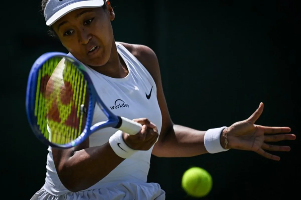 Japan's Naomi Osaka plays a forehand return to Russia's Anastasia Pavlyuchenkova during their women's singles third round tennis match on the fifth day of the 2025 Wimbledon Championships at The All England Lawn Tennis and Croquet Club in Wimbledon, southwest London, on July 4, 2025. Kirill KUDRYAVTSEV / AFP