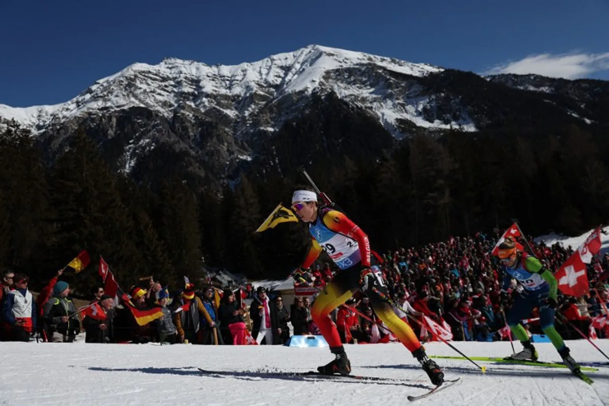 Belgium's Lotte Lie (C) competes during the Women 10 km Pursuit event of the IBU Biathlon World Championship of Lenzerheide, eastern Switzerland, on February 16, 2025.  FRANCK FIFE / AFP