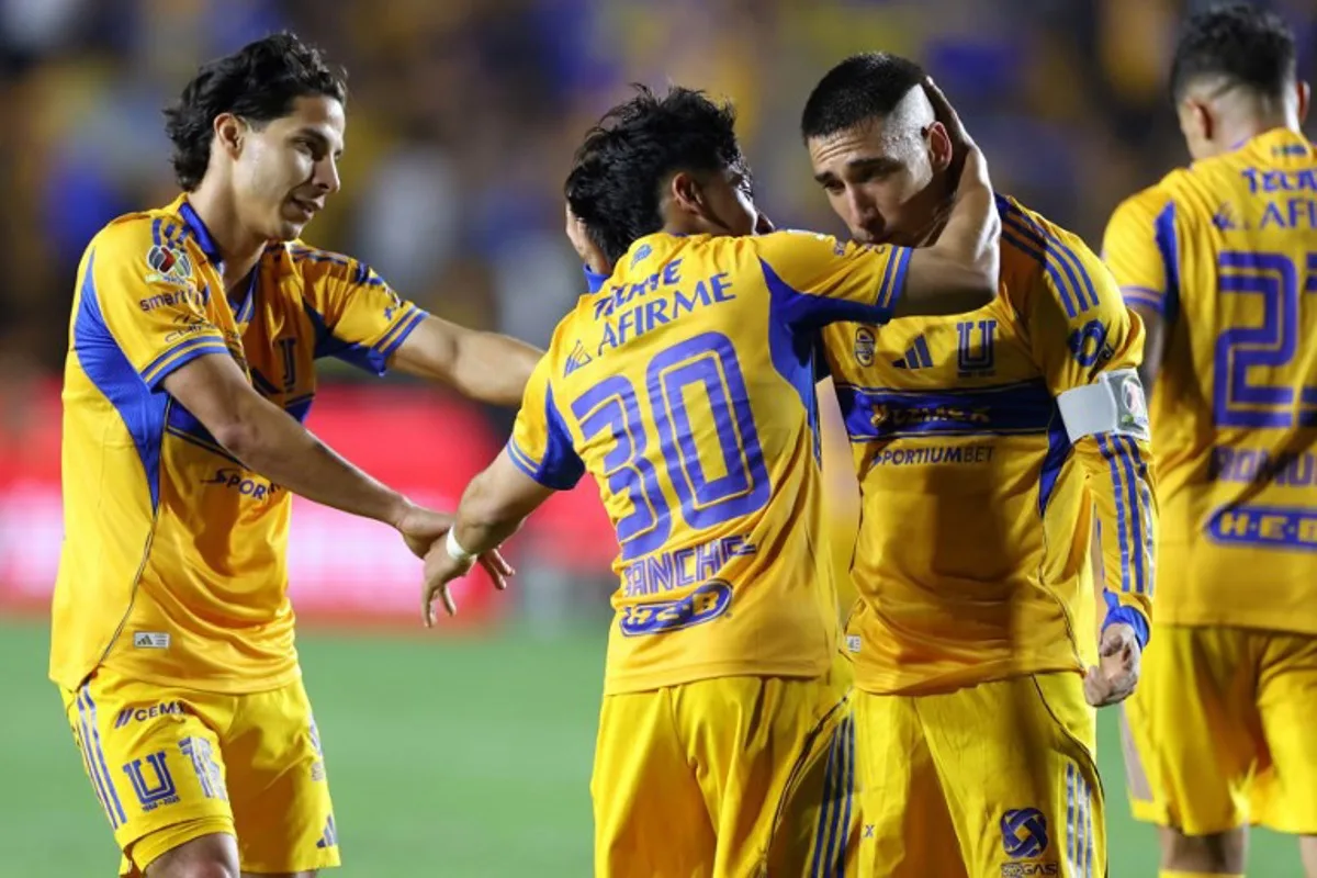 Tigres' forward #30 Diego Sanchez celebrates with Uruguayan midfielder #08 Fernando Gorriaran (R) and midfielder #16 Diego Lainez after scoring his team's third goal during the Mexican League Clausura Tournament quarterfinal first leg football match between Tigres and Guadalajara at the Universitario stadium in Monterrey, Nuevo Leon state, Mexico on May 2, 2026.  Julio Cesar AGUILAR / AFP