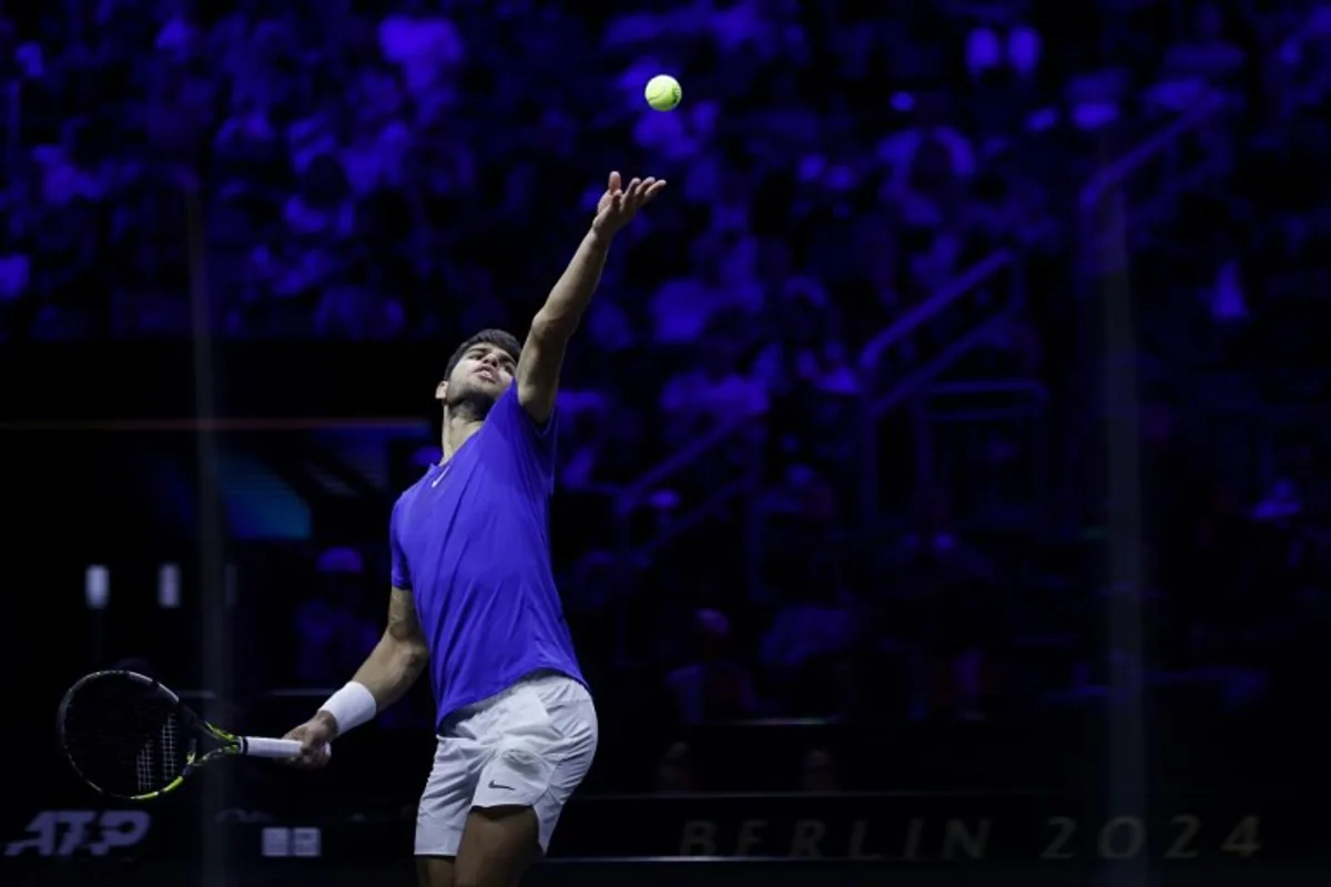 Spain's Carlos Alcaraz of Team Europe serves the ball to USA's Taylor Fritz of Team World during their 2024 Laver Cup men's singles tennis match in Berlin, Germany on September 22, 2024.  Odd ANDERSEN / AFP