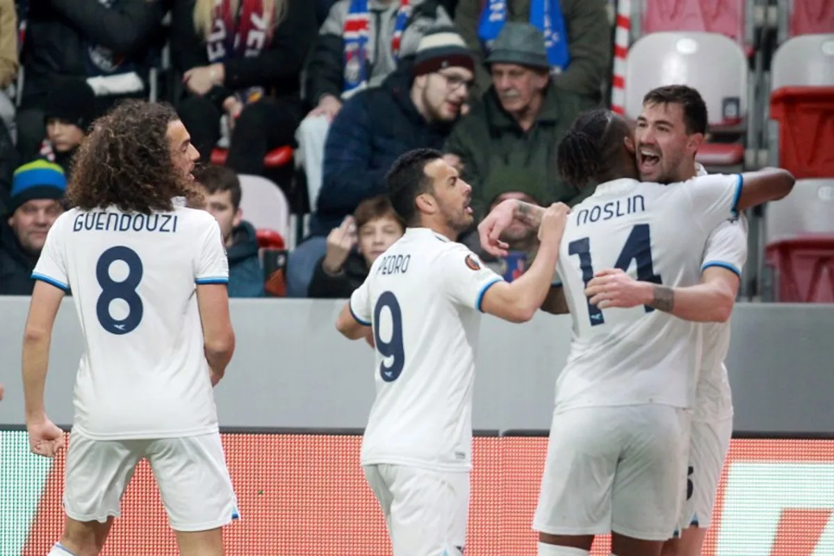 Lazio's players celebrate after Lazio's Italian defender #13 Alessio Romagnoli (R) scored his team's first goal during the UEFA Europa League last 16, 1st leg football match between FC Viktoria Plzen and S S Lazio in Plzen, Czech Republic, on March 6, 2025.  MILAN KAMMERMAYER / AFP