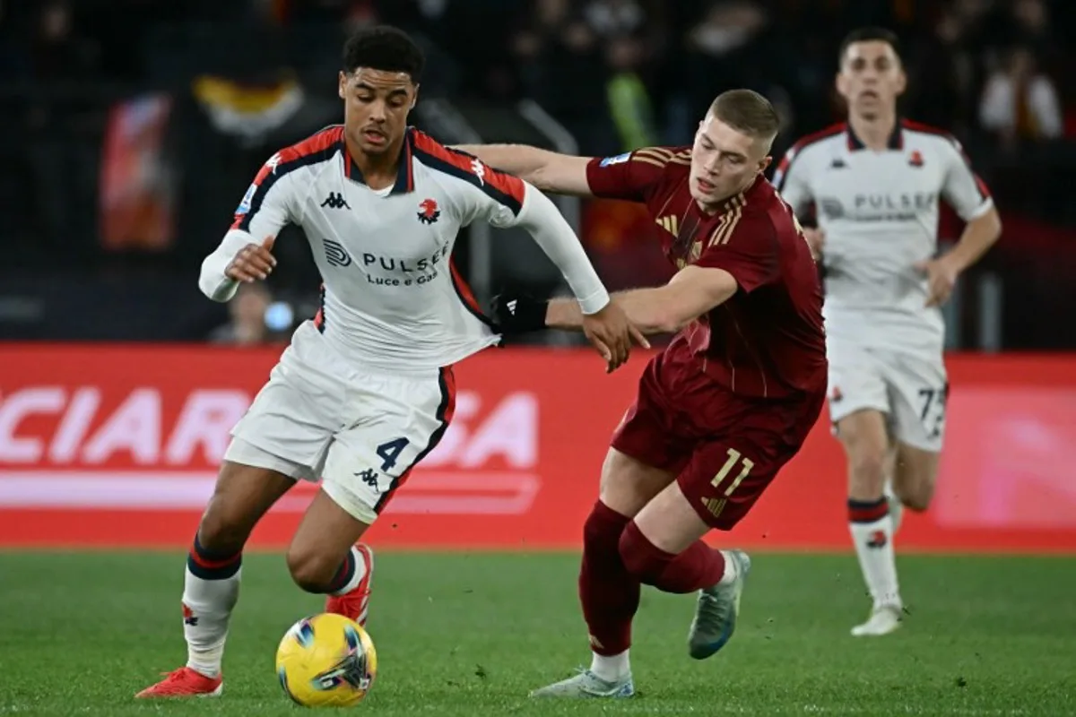 Genoa's Belgian midfielder #04 Koni de Winter fights for the ball with Roma's Ukrainian forward #11 Artem Dovbyk (R) during the Italian Serie A football match between AS Roma and Genoa at the Olympic Stadium in Rome on January 17, 2025.  Filippo MONTEFORTE / AFP