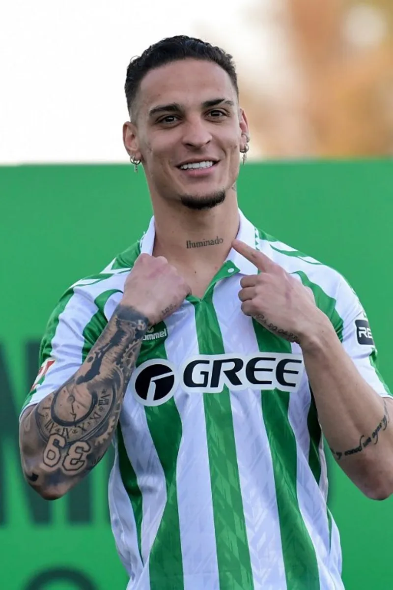 Real Betis' new Brazilian player Antony Santos points to a tattoo during his presentation at the Ciudad Deportivo Luis del Sol in Seville on February 5, 2025. CRISTINA QUICLER / AFP