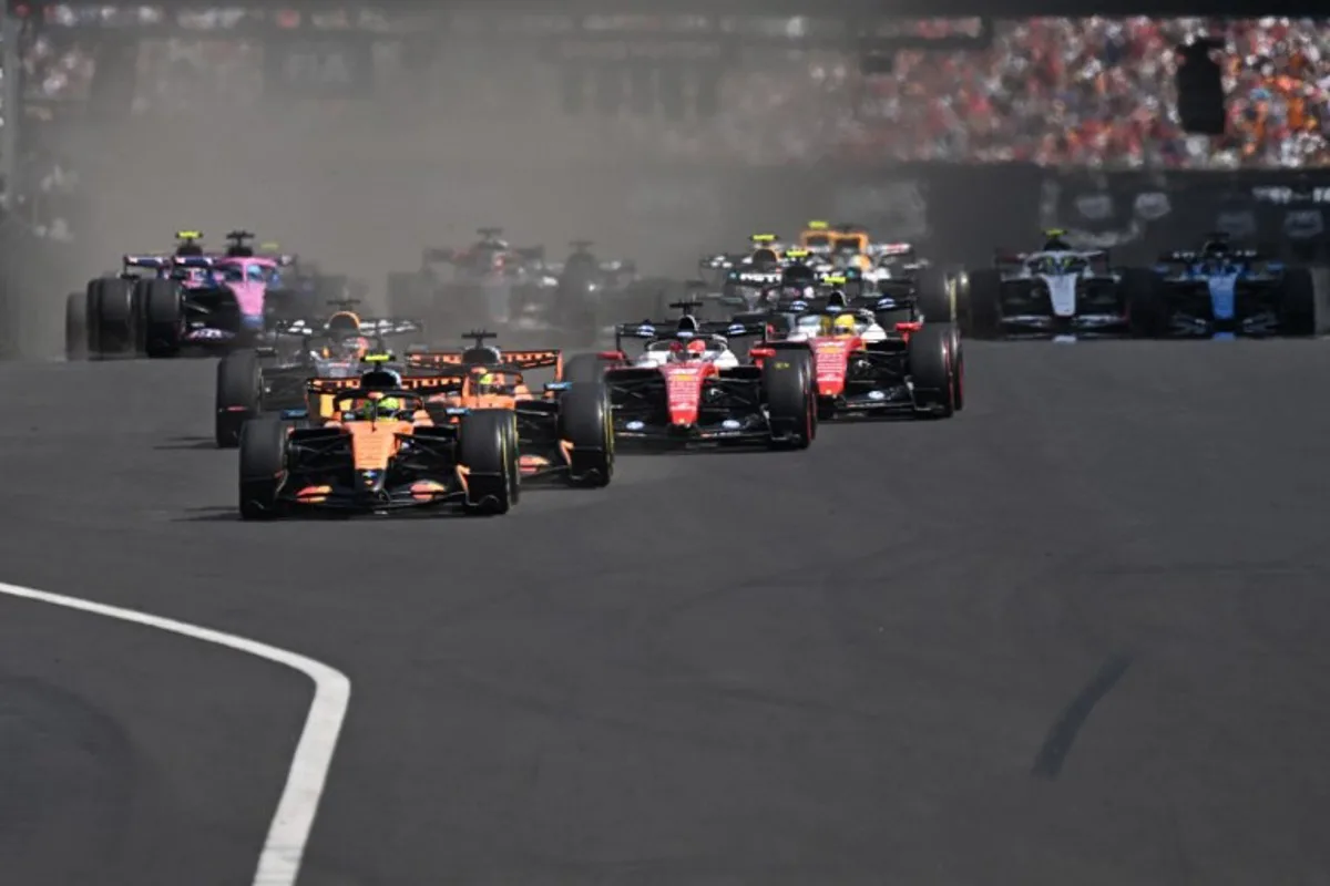 McLaren's British driver Lando Norris (C) followed by McLaren's Australian driver Oscar Piastri (C-R) and other cars compete during the Formula One Hungarian Grand Prix at the Hungaroring racetrack in Mogyorod near Budapest, Hungary, on July 26, 2026. Attila KISBENEDEK / AFP