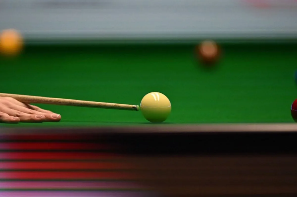 England's Judd Trump plays a shot during the Masters snooker tournament final against Wales' Mark Williams at Alexandra Palace in London on January 15, 2023.  JUSTIN TALLIS / AFP