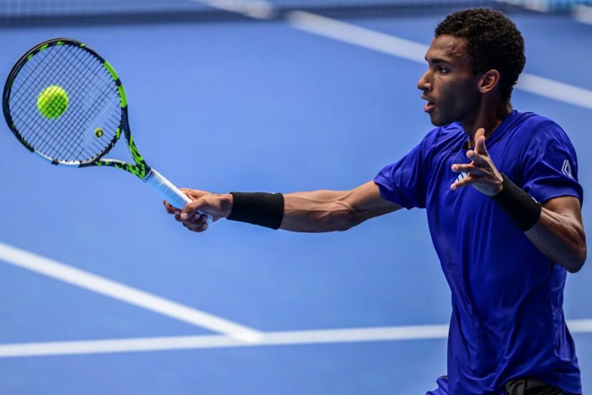 Canada's Felix Auger-Aliassime hits a return to Japan's Yoshihito Nishioka during their men's singles match at the Japan Open tennis tournament in Tokyo on September 26, 2024.  Yuichi YAMAZAKI / AFP