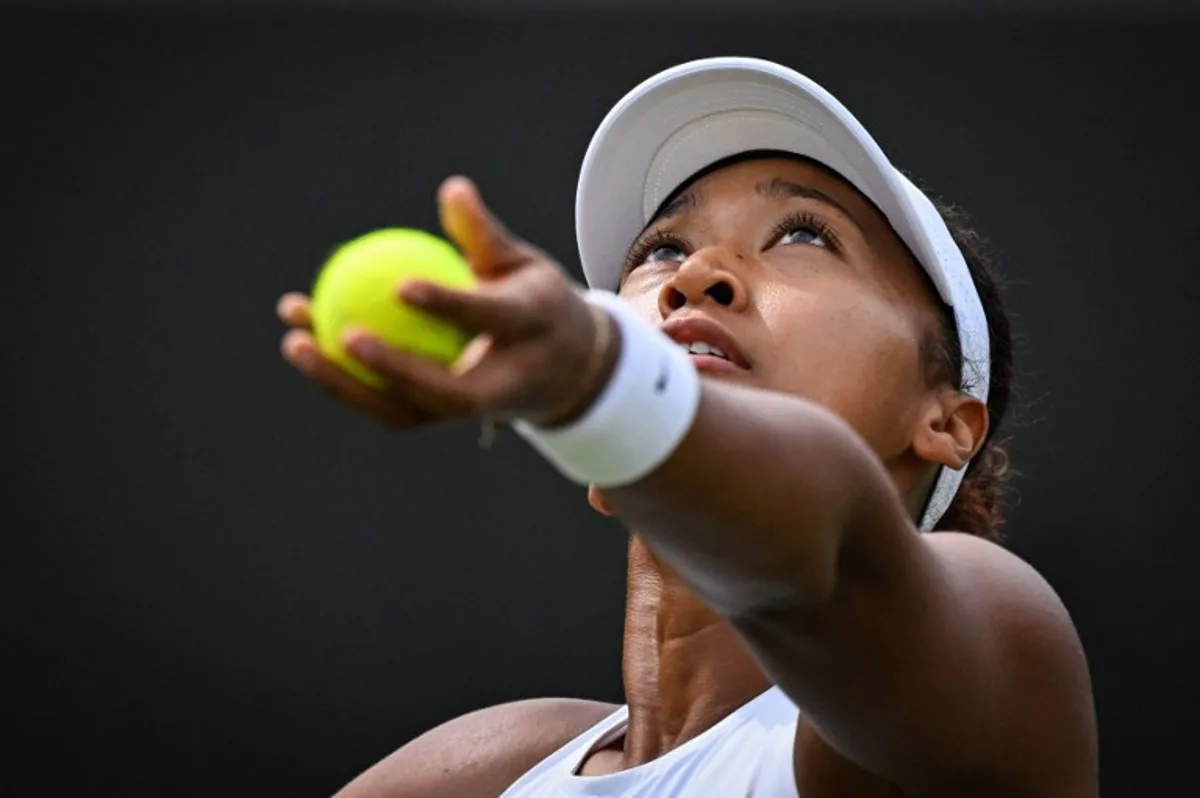 Japan's Naomi Osaka serves to Russia's Anastasia Pavlyuchenkova during their women's singles third round tennis match on the fifth day of the 2025 Wimbledon Championships at The All England Lawn Tennis and Croquet Club in Wimbledon, southwest London, on July 4, 2025.  Kirill KUDRYAVTSEV / AFP