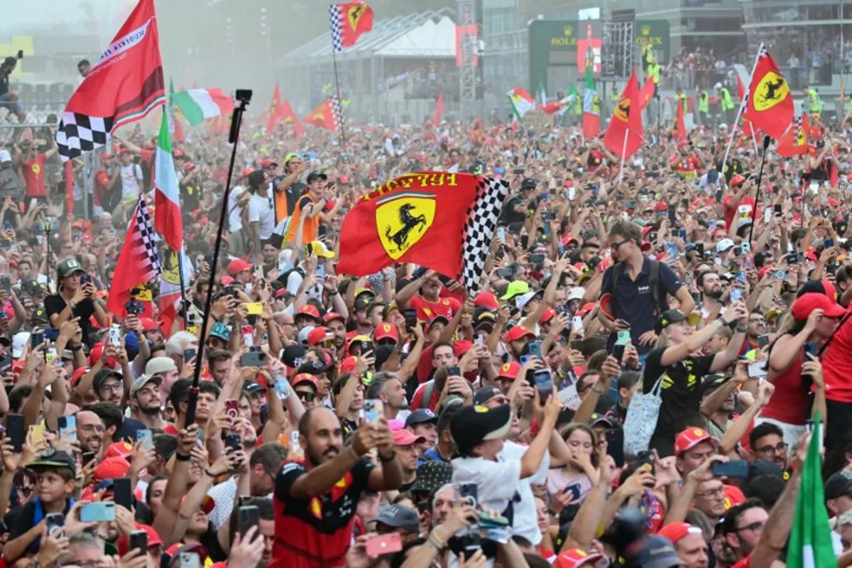 Supporters and Ferrari's fans celebrate Ferrari's Monegasque driver Charles Leclerc's victory after the Italian Formula One Grand Prix race at Autodromo Nazionale Monza circuit, in Monza on September 1, 2024.  Andrej ISAKOVIC / AFP