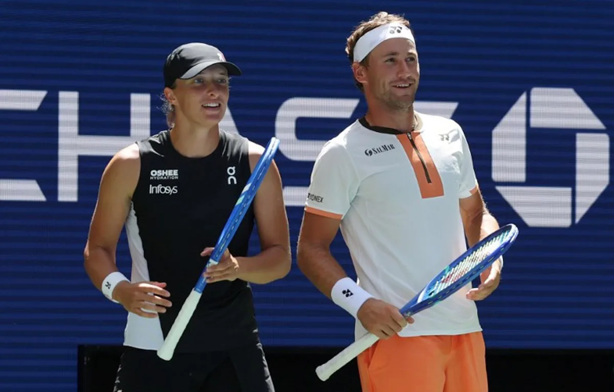 Norway's Casper Ruud (R) and Poland's Iga Swiatek react after a point against Madison Keys and Frances Tiafoe of the USA during their Mixed Doubles Match at the US Open tennis tournament at the USTA Billie Jean King National Tennis Center in New York City, on August 19, 2025. TIMOTHY A. CLARY / AFP