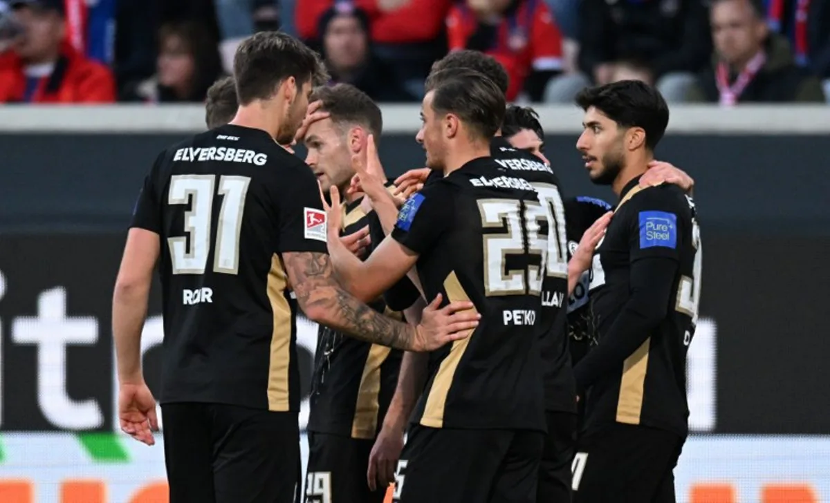 Elversberg's German midfielder #25 Lukas Petkov (R) celebrates with teammates scoring the opening goal during the German Bundesliga relegation first-leg football match  between FC Heidenheim and SV Elversberg in Heidenheim on May 22, 2025.  THOMAS KIENZLE / AFP