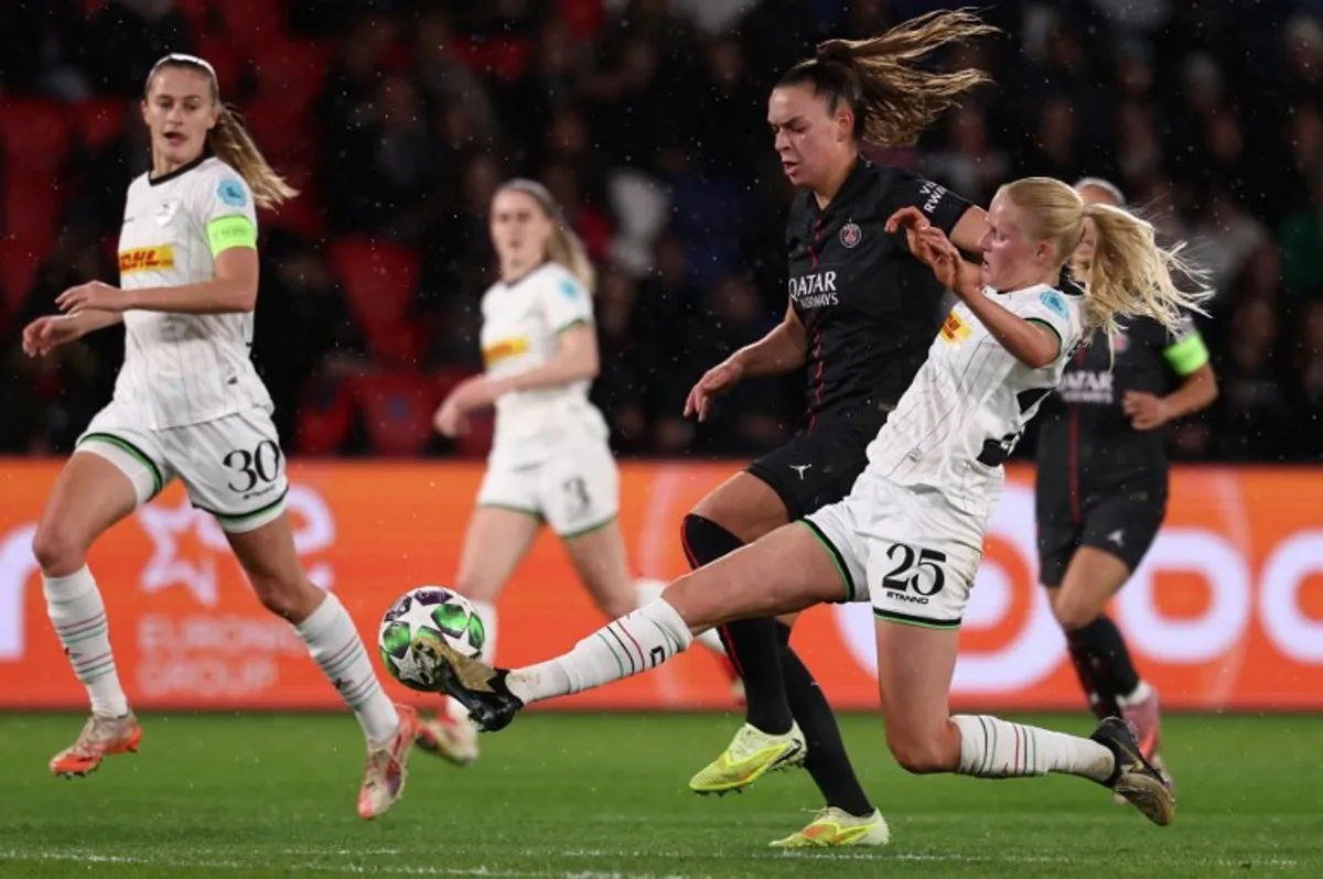 Paris Saint-Germain's Dutch forward #17 Romee Leuchter (2nd R) fights OH Louvain's Belgian midfielder #30 Julie Biesmans (L) and OH Louvain's Dutch defender #25 Linde Veefkind (R) during the UEFA Women's Champions League first round day five football match between Paris Saint-Germain and OH Louvain at the Parc des Princes in Paris on December 9, 2025. FRANCK FIFE / AFP