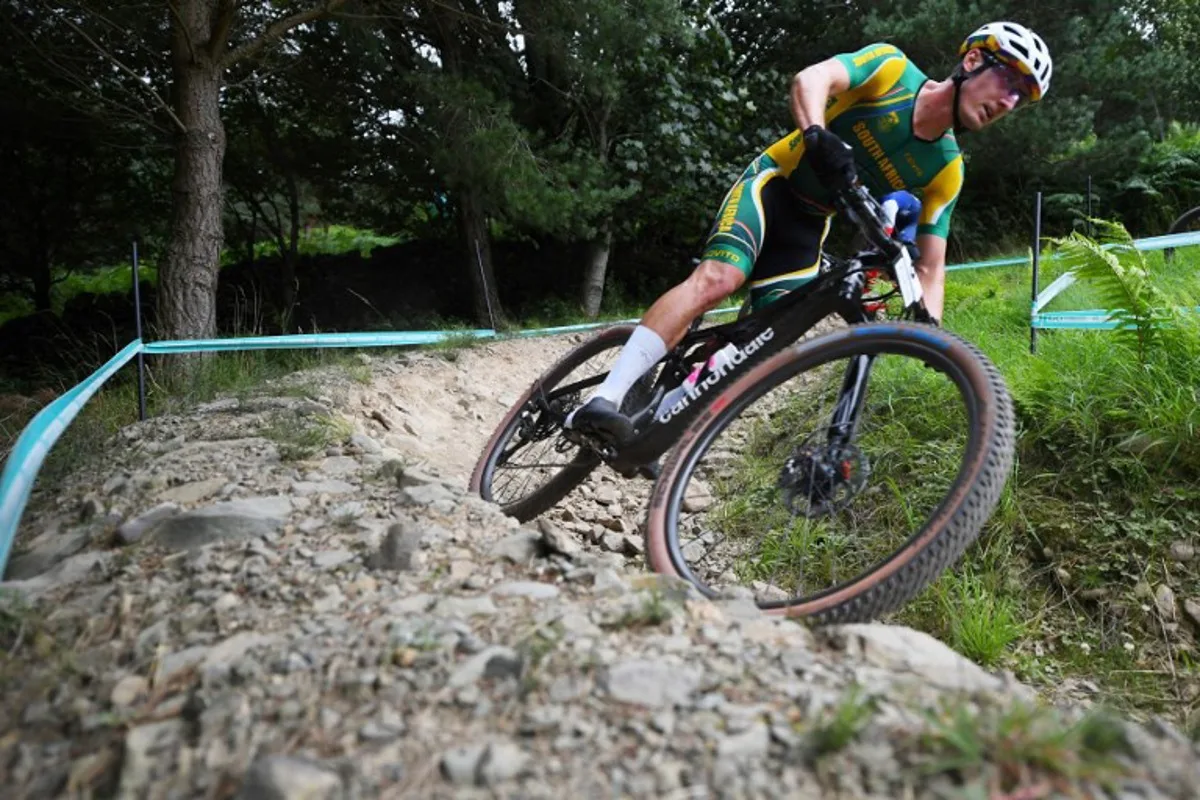 South Africa's Alan Hatherly takes part in the men's Elite cross-country Olympic mountain bike race during the Cycling World Championships in Glentress Forest, Scotland on August 12, 2023.  ANDY BUCHANAN / AFP