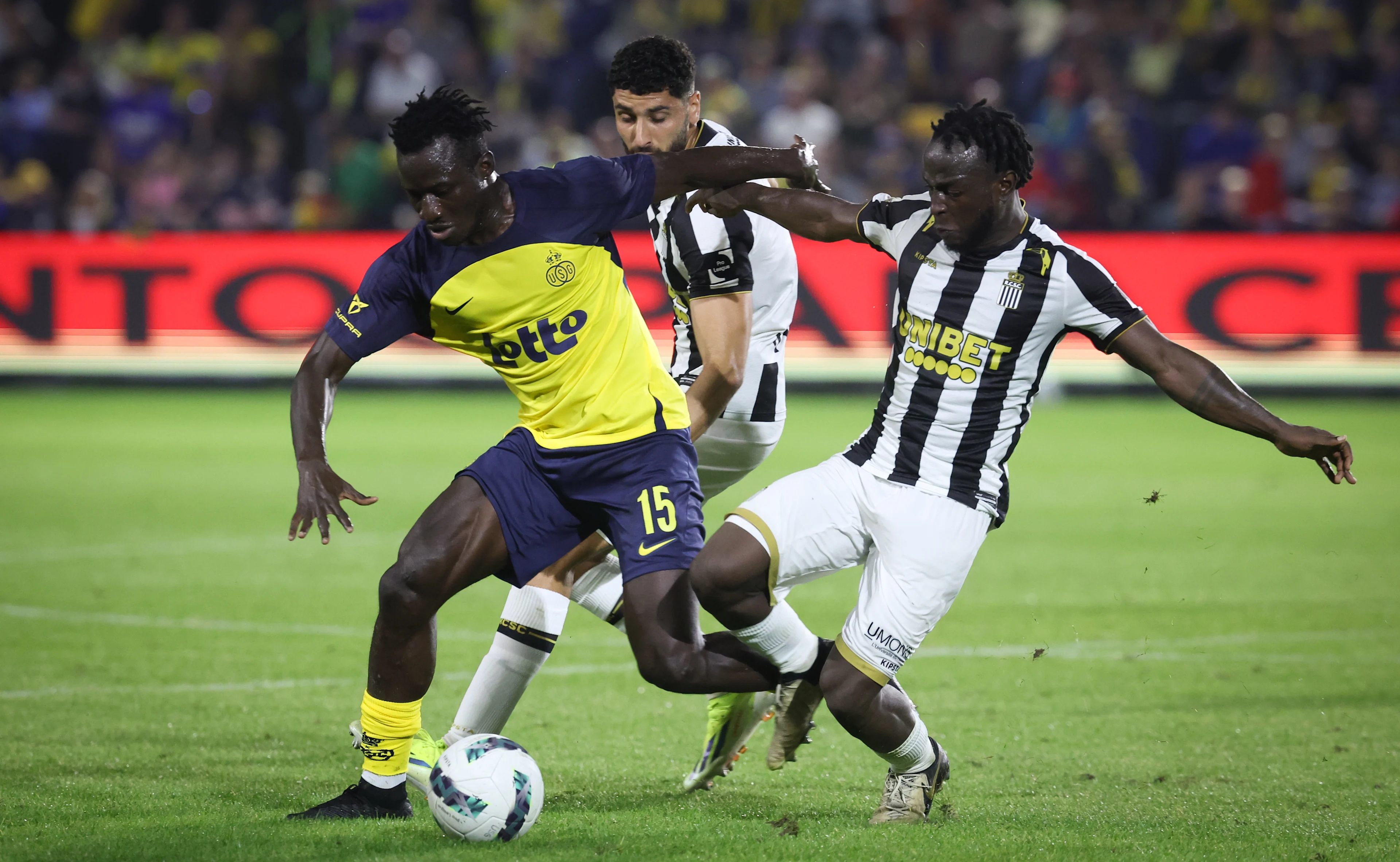 Union's Mamadou Traore and Charleroi's Parfait Guiagon fight for the ball during a soccer match between RUSG Royale Union Saint-Gilloise and Sporting Charleroi, in Brussels, on day 04 of the 2023-2024 season of the 'Jupiler Pro League' first division of the Belgian championship, Friday 16 August 2024. BELGA PHOTO VIRGINIE LEFOUR