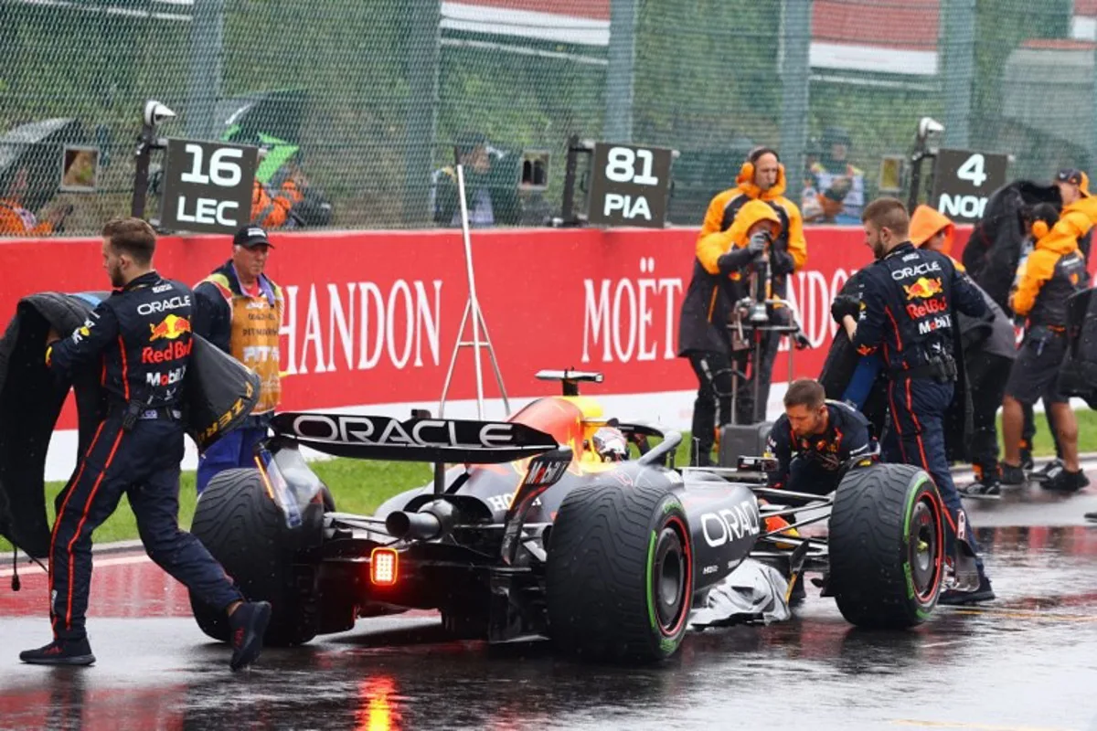 Red Bull Racing's mechanics prepare the car of Dutch driver Max Verstappen before the formation lap ahead of the start of the Formula One Belgian Grand Prix at the Spa-Francorchamps circuit in Spa, on July 27, 2025. SIMON WOHLFAHRT / AFP