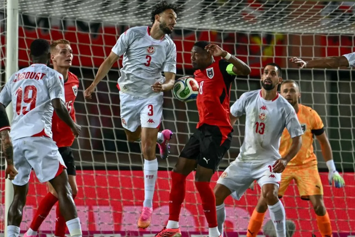 Austria's defender #08 David Alaba and Tunisia's defender #03 Montassar Talbi vie for the ball during the friendly football match between Austria and Tunisia in Vienna, Austria on June 1, 2026 ahead of the 2026 FIFA World Cup football tournament.  Joe Klamar / AFP