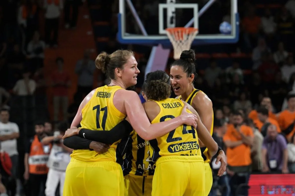 Fenerbahce's Belgian forward #11 Emma Meesseman (L) celebrates with her teammates after winning the women's FIBA Euroleague basketball semifinal match between Fenerbahce Alagoz Holding and Cukurova Basketbol Mersin at Servet Tazegul Spor Salonu arena, in Mersin, on April 12, 2024.  OZAN KOSE / AFP