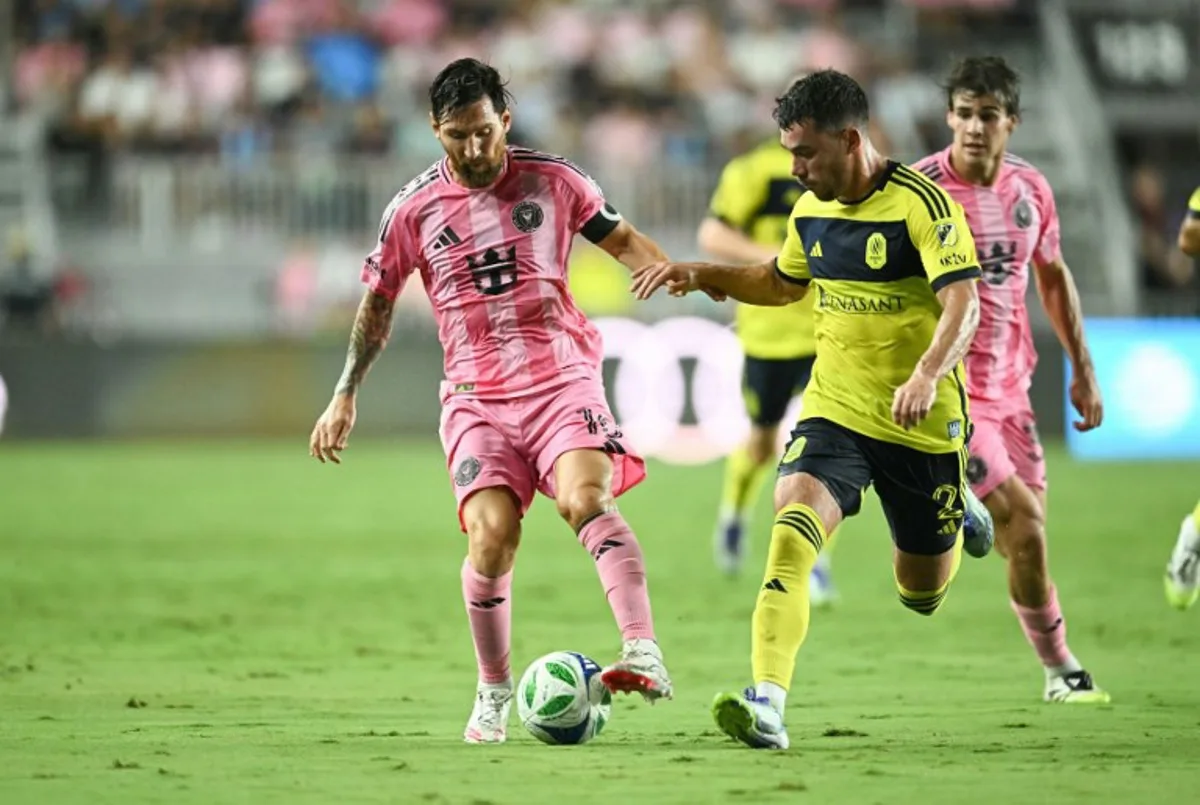 Inter Miami's Argentine forward #10 Lionel Messi and Nashville's US defender #02 Daniel Lovitz vie for the ball during the Major League Soccer (MLS) regular season soccer match between Inter Miami CF and Nashville SC at Chase Stadium in Fort Lauderdale, Florida on July 12, 2025. CHANDAN KHANNA / AFP